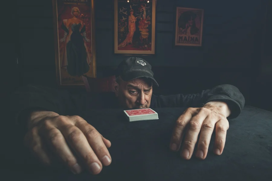 David Williamson behind a card table with his hands stretched forward
